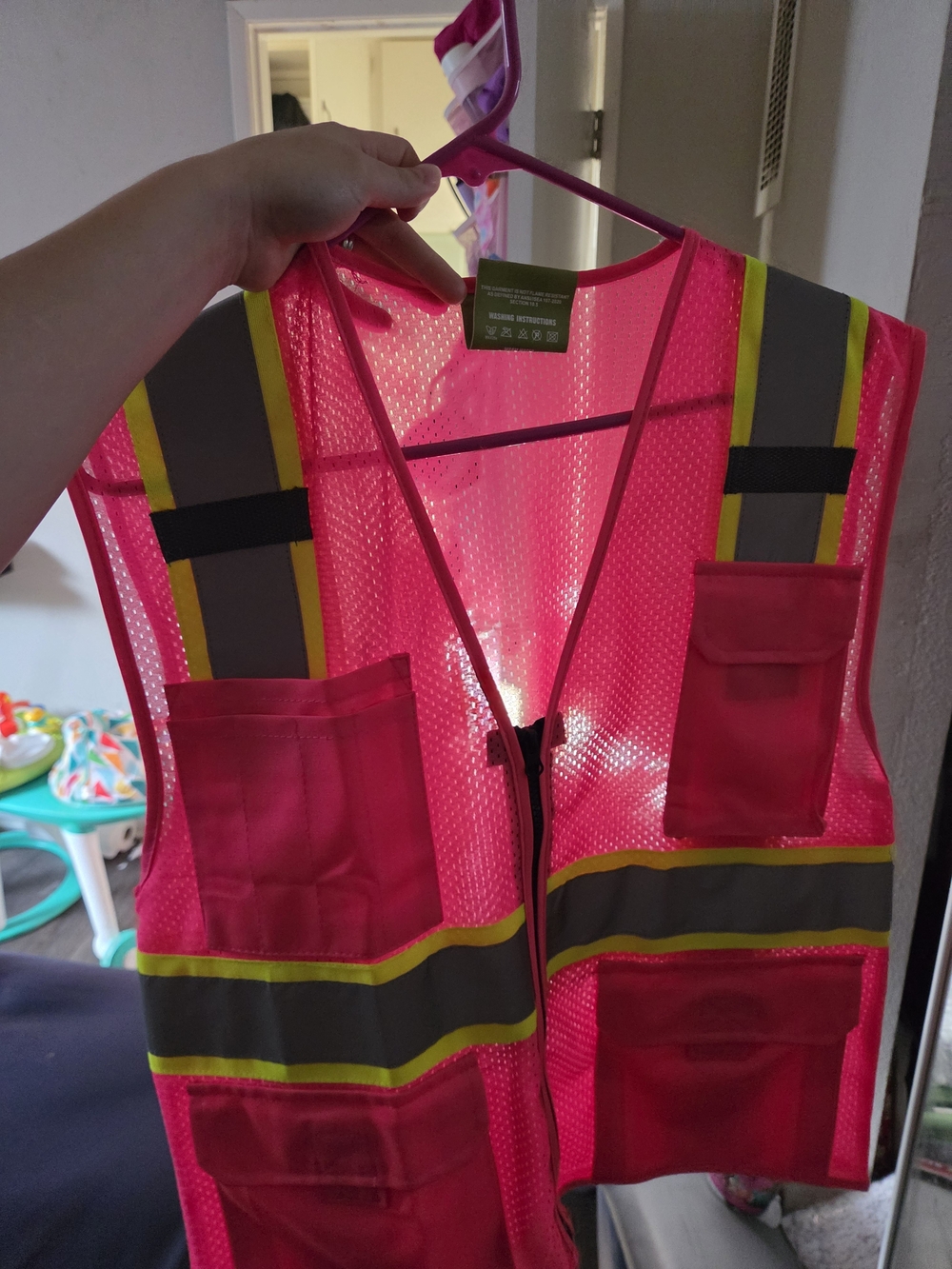 High-Visibility Pink Safety Vest with Reflective Stripes and Front Pockets